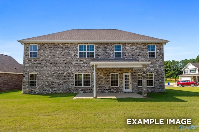 back of house featuring a lawn and a patio area