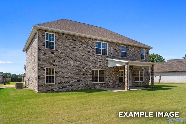 back of property with a lawn, central air condition unit, and a patio