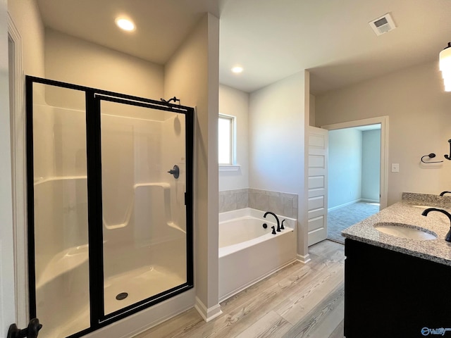 122 Parvin Way Dr, Hazel Green, AL 35750 - full bath with a shower stall, a bath, visible vents, a sink, and wood finished floors