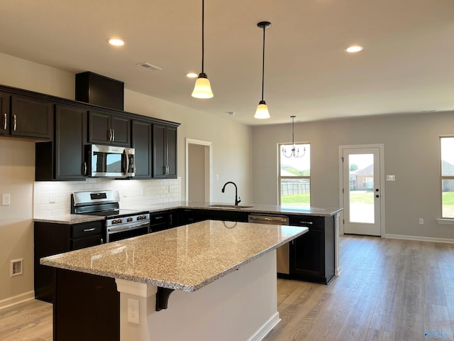 122 Parvin Way Dr, Hazel Green, AL 35750 - kitchen featuring visible vents, a sink, a peninsula, light wood finished floors, and stainless steel appliances