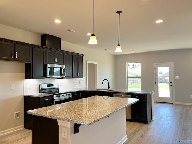 122 Parvin Way Dr, Hazel Green, AL 35750 - kitchen with a center island, a sink, appliances with stainless steel finishes, a peninsula, and light wood finished floors