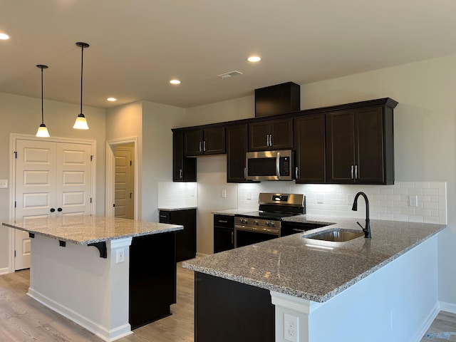 122 Parvin Way Dr, Hazel Green, AL 35750 - kitchen featuring a sink, light wood-style flooring, light stone counters, and stainless steel appliances