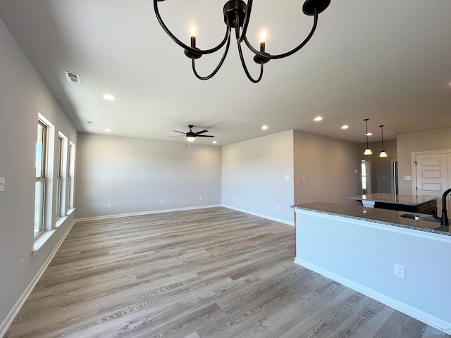 122 Parvin Way Dr, Hazel Green, AL 35750 - unfurnished living room featuring ceiling fan with notable chandelier, visible vents, recessed lighting, light wood finished floors, and baseboards
