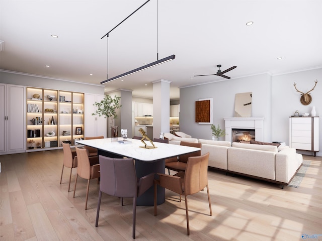 dining space with ceiling fan, light wood-type flooring, and crown molding