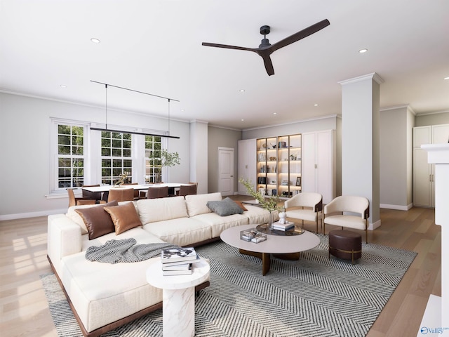 living room with ceiling fan, ornamental molding, and light wood-type flooring