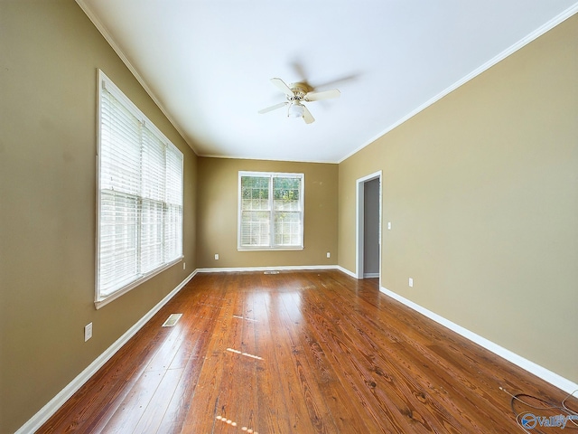 unfurnished room featuring hardwood / wood-style flooring, ceiling fan, and ornamental molding