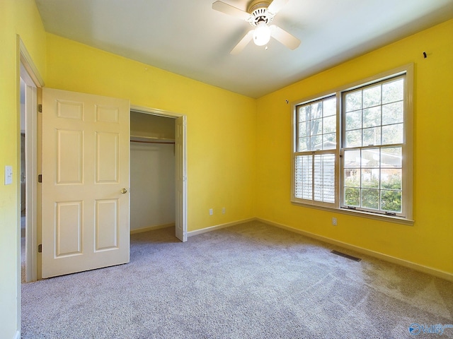 unfurnished bedroom with carpet floors, a closet, and ceiling fan