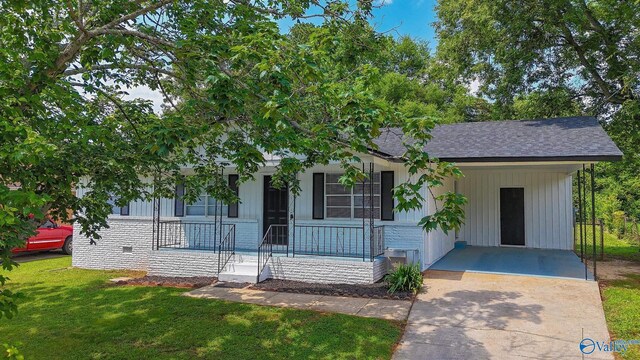 629 Dawson Ter NW, Huntsville, AL 35811 - view of front of property with covered porch, driveway, a front lawn, a carport, and a shingled roof