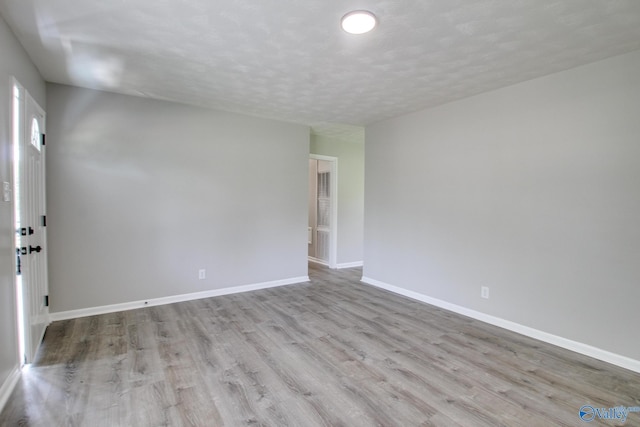 629 Dawson Ter NW, Huntsville, AL 35811 - spare room with wood finished floors and a textured ceiling