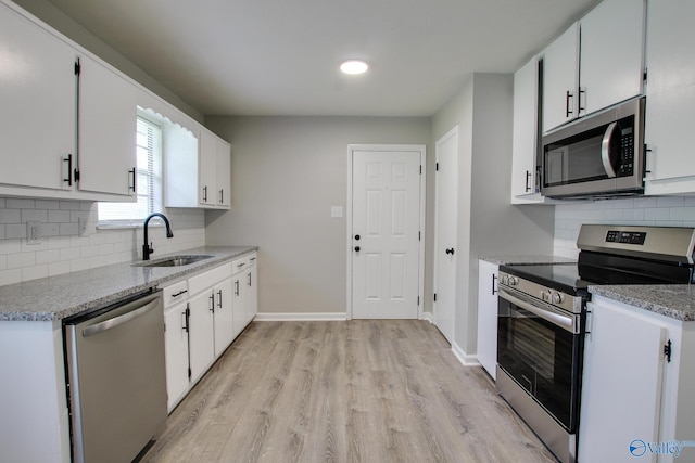 629 Dawson Ter NW, Huntsville, AL 35811 - kitchen featuring stainless steel appliances, light wood-style flooring, backsplash, white cabinetry, and recessed lighting