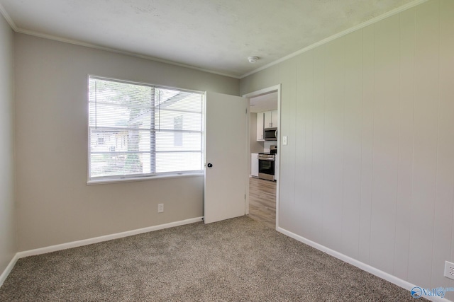 629 Dawson Ter NW, Huntsville, AL 35811 - spare room with light colored carpet, crown molding, and a smoke detector