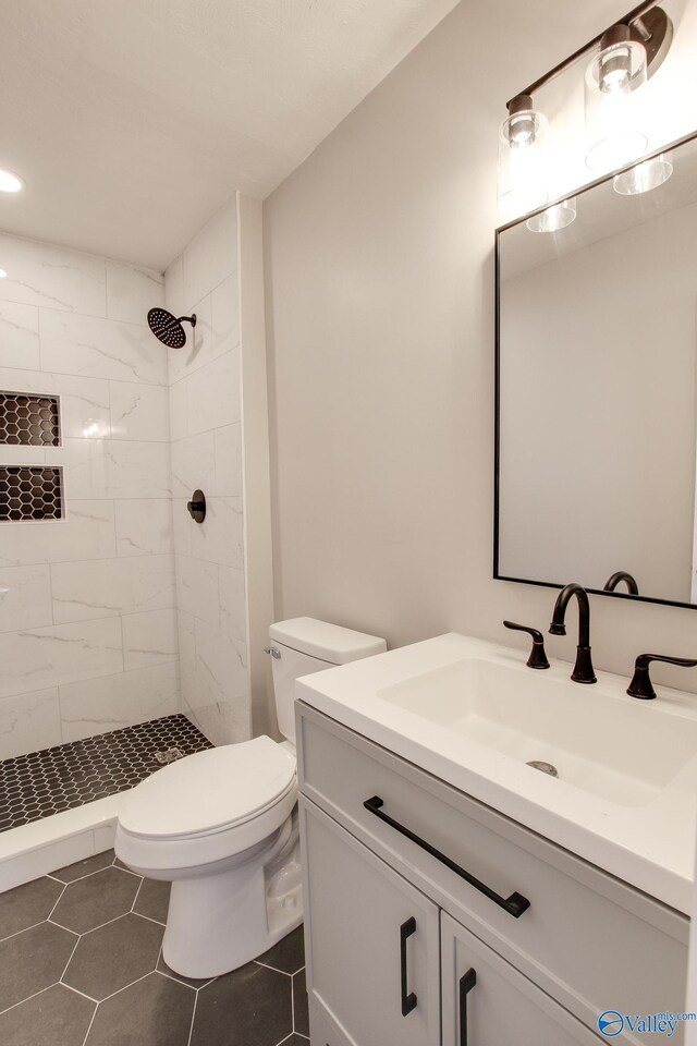 629 Dawson Ter NW, Huntsville, AL 35811 - bathroom with vanity, a tile shower, and tile patterned floors