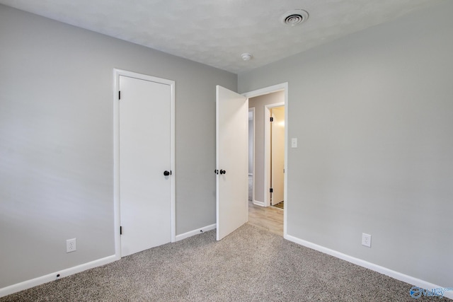 629 Dawson Ter NW, Huntsville, AL 35811 - unfurnished bedroom featuring light carpet and baseboards