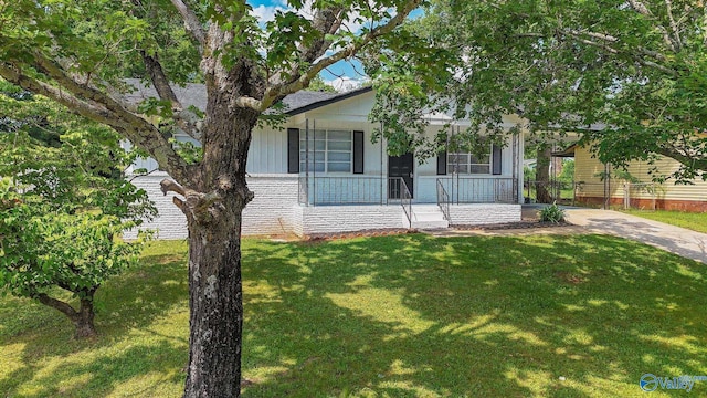 629 Dawson Ter NW, Huntsville, AL 35811 - view of front of house featuring covered porch, a front yard, and brick siding