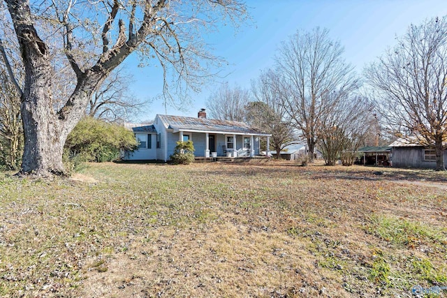 ranch-style home with covered porch and a front yard