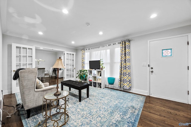 living room featuring crown molding and dark hardwood / wood-style floors