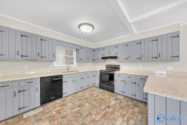kitchen featuring visible vents, gray cabinetry, a sink, under cabinet range hood, and black appliances