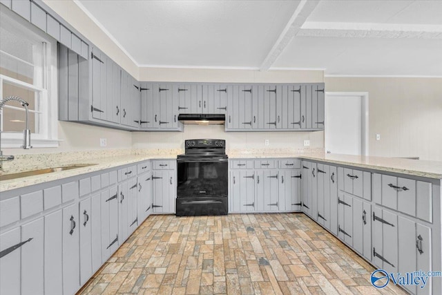 kitchen with brick floor, gray cabinetry, under cabinet range hood, black range with electric cooktop, and a sink