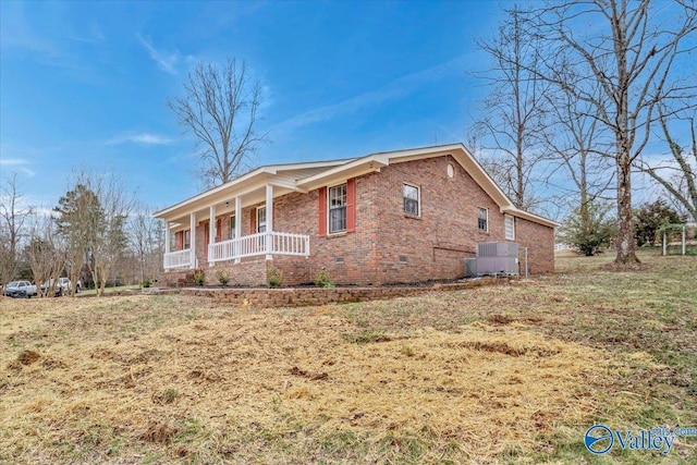 view of property exterior with brick siding, a yard, central air condition unit, covered porch, and crawl space