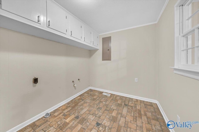 clothes washing area with hookup for an electric dryer, baseboards, ornamental molding, cabinet space, and electric panel