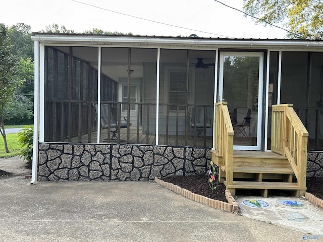 view of exterior entry featuring metal roof