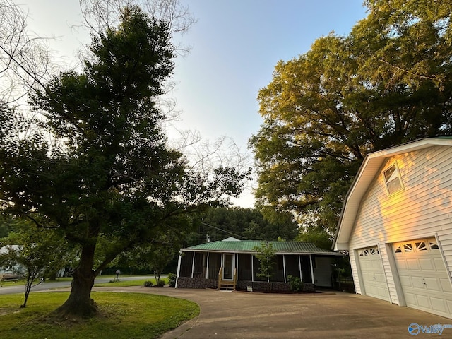 surrounding community with concrete driveway and a lawn