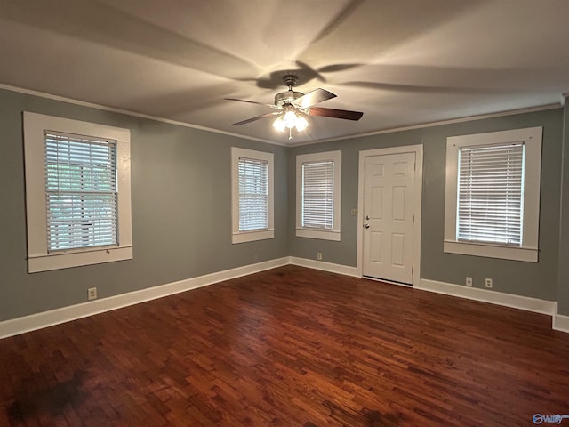unfurnished room with baseboards, ornamental molding, and dark wood-type flooring