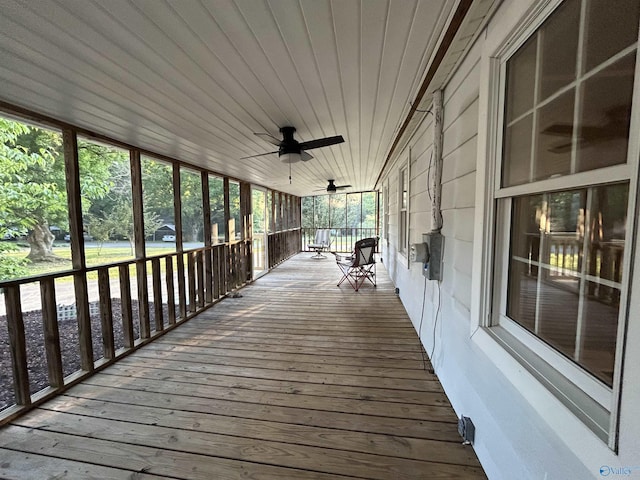 wooden terrace with ceiling fan and a porch