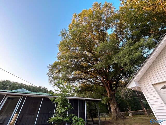 view of front facade featuring a front lawn, a garage, and an outbuilding