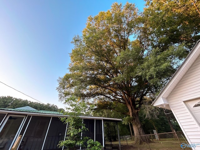 exterior space with fence and a sunroom