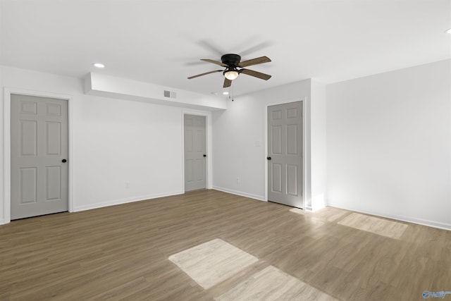 empty room featuring ceiling fan and light hardwood / wood-style flooring