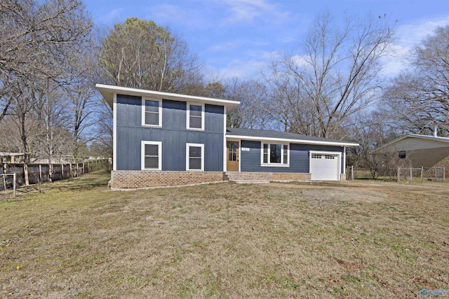 view of front of property featuring a garage and a front lawn