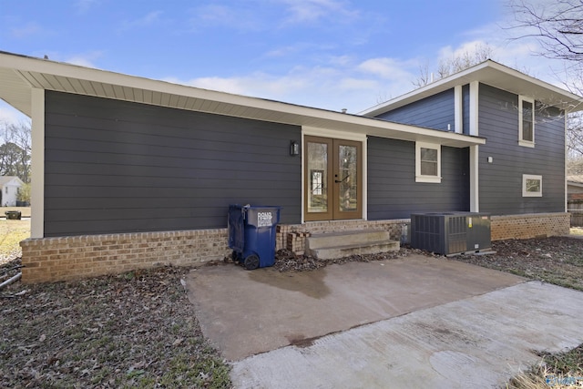 view of front of home with french doors, a patio, and cooling unit