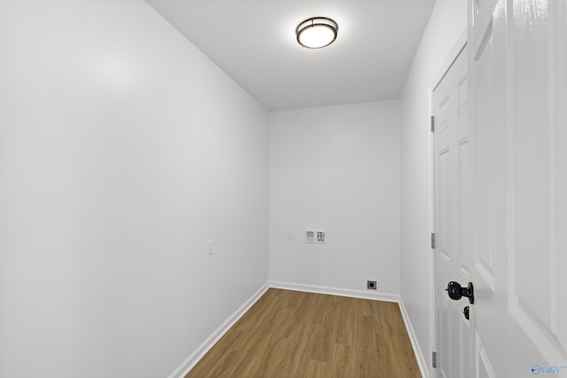 laundry room with hardwood / wood-style floors and hookup for an electric dryer