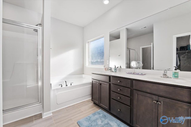 bathroom with vanity, hardwood / wood-style flooring, and separate shower and tub