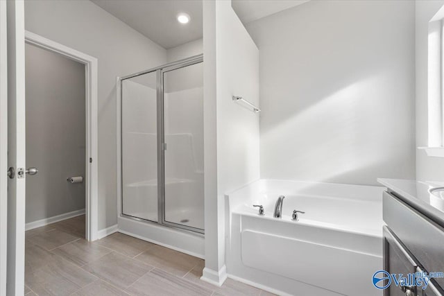 bathroom with vanity and plus walk in shower