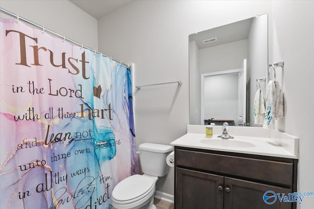 bathroom with curtained shower, vanity, and toilet