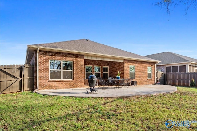 back of house featuring a lawn and a patio