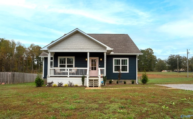 view of front of home with a porch and a front yard