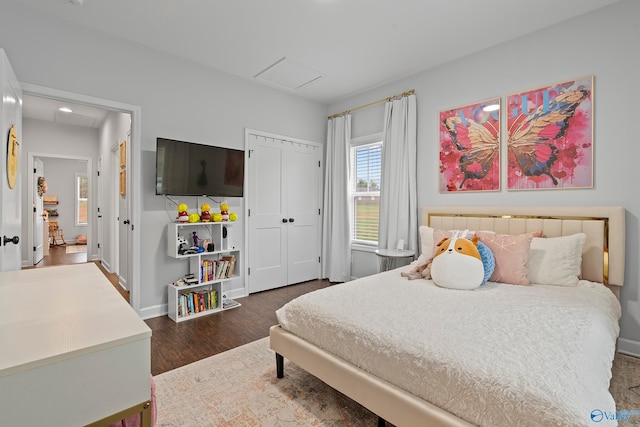 bedroom with a closet and dark hardwood / wood-style floors