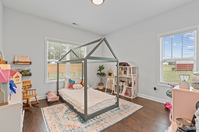 bedroom with dark hardwood / wood-style flooring