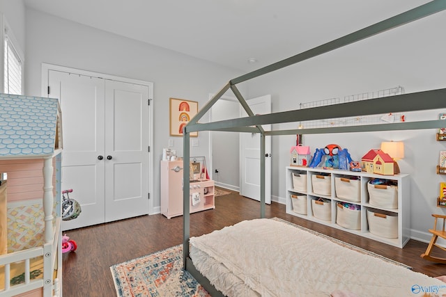 bedroom featuring dark hardwood / wood-style floors and a closet