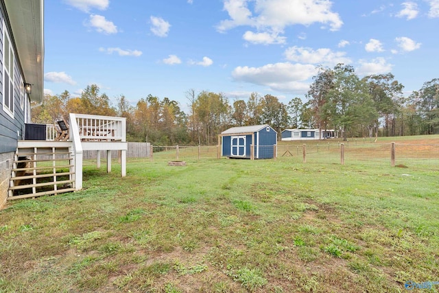 view of yard with a shed and a wooden deck