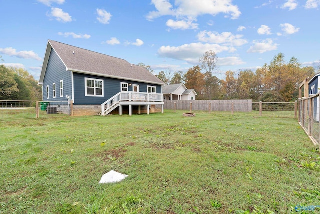 back of house featuring a yard, a deck, and cooling unit