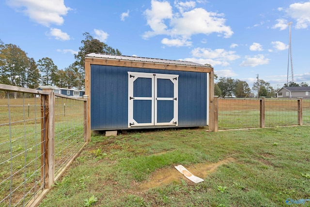 view of outbuilding featuring a yard