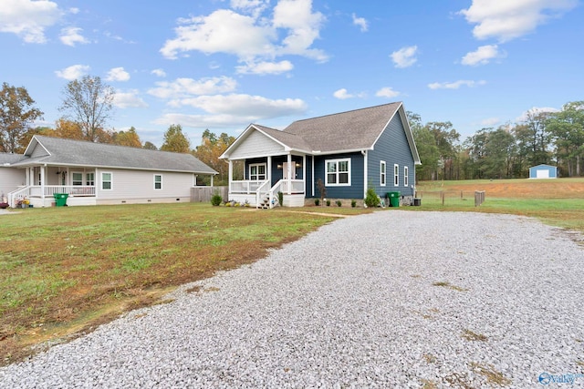 view of front facade with covered porch and a front yard