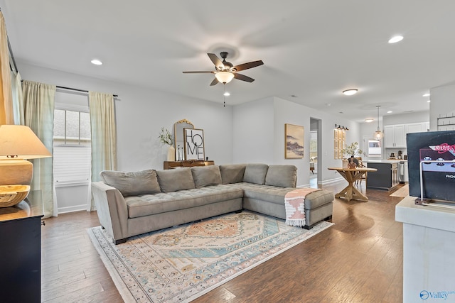 living room featuring hardwood / wood-style flooring and ceiling fan