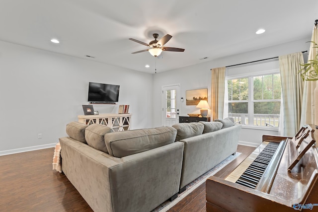 living room with ceiling fan and dark hardwood / wood-style flooring