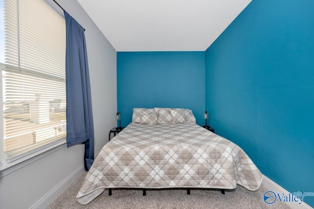 bedroom with carpet flooring and baseboards