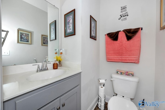 half bathroom with toilet and vanity